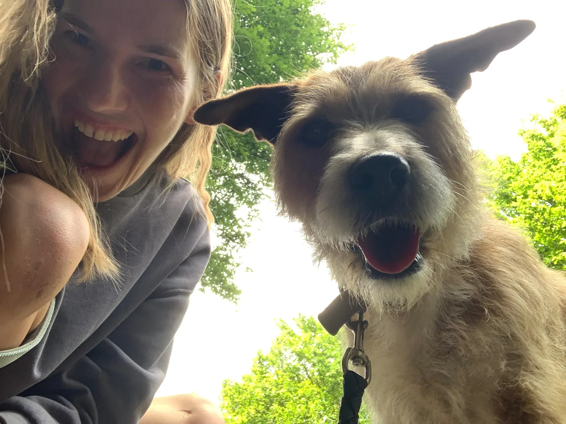 Buddy smiling beside Lilli outdoors