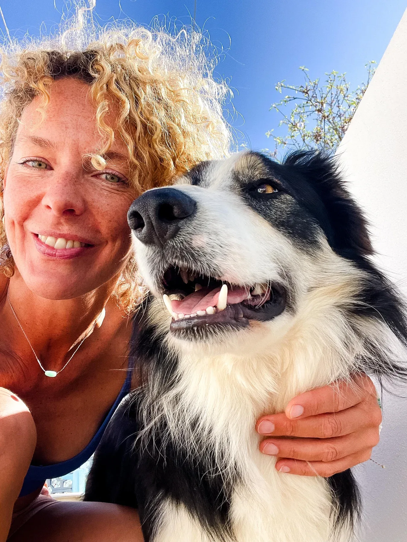 Mascot smiling beside Elke outdoors