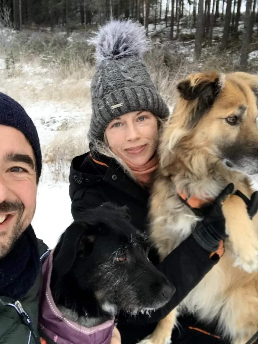 Polly held close by her family outdoors in winter